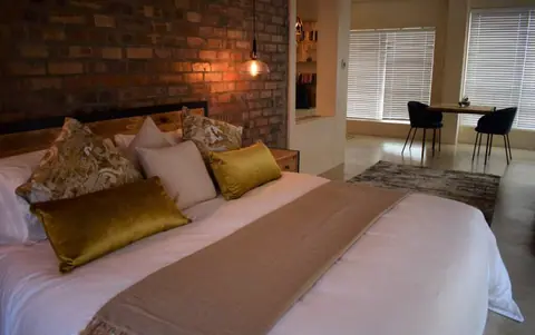 Suite with a king bed and a small table for two