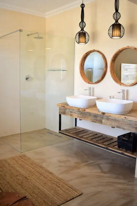 Bathroom with twin basins, round mirrors and a walk-in shower