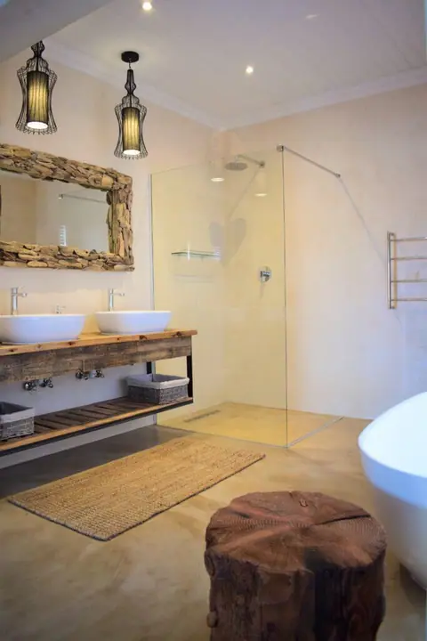 Bathroom with twin basins, a walk-in shower and a free-standing bath