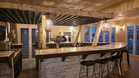 The boat-bar and lounge under a beamed ceiling